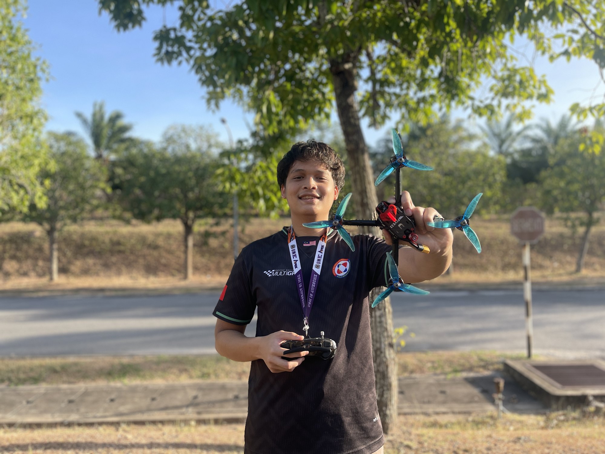 Adam Roslan holding an FPV drone